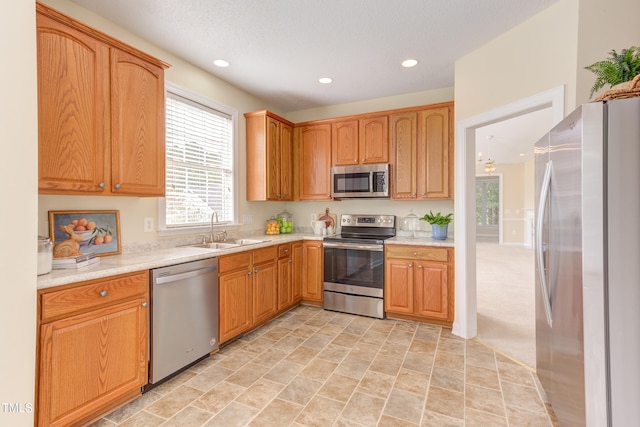 2026 Heritage Pines Dr, Cary, NC 27519 - kitchen featuring stainless steel appliances, light countertops, recessed lighting, healthy amount of natural light, and stone finish floors