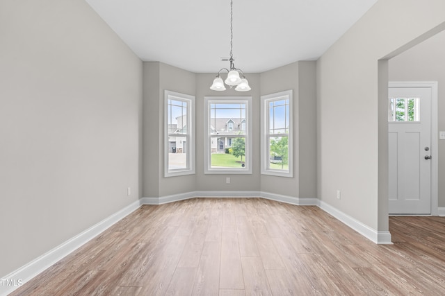 44 Good Morning Ln, Garner, NC 27529 - unfurnished dining area with light wood-style floors, a chandelier, and baseboards