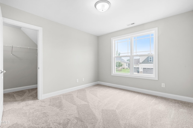 44 Good Morning Ln, Garner, NC 27529 - unfurnished bedroom featuring carpet floors, baseboards, a walk in closet, and a closet