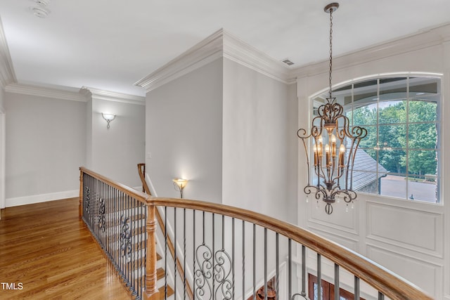104 Bellagio Dr, Apex, NC 27539 - hall with an upstairs landing, wood finished floors, a chandelier, crown molding, and baseboards
