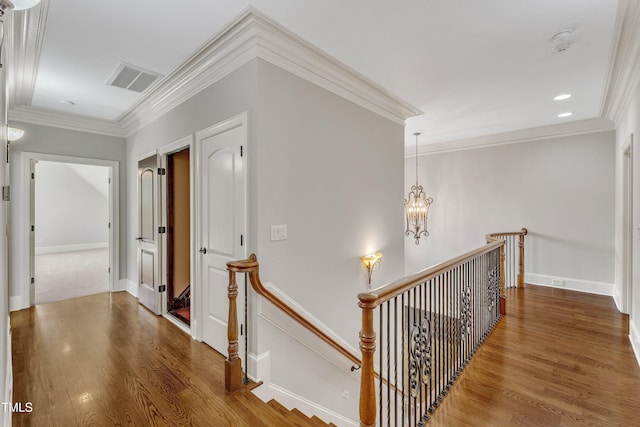 104 Bellagio Dr, Apex, NC 27539 - hall with an upstairs landing, crown molding, wood finished floors, a chandelier, and baseboards