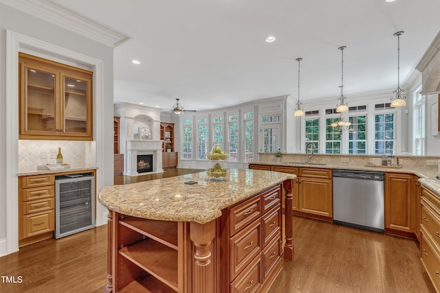 104 Bellagio Dr, Apex, NC 27539 - kitchen with beverage cooler, stainless steel dishwasher, dark wood-style floors, crown molding, and a sink