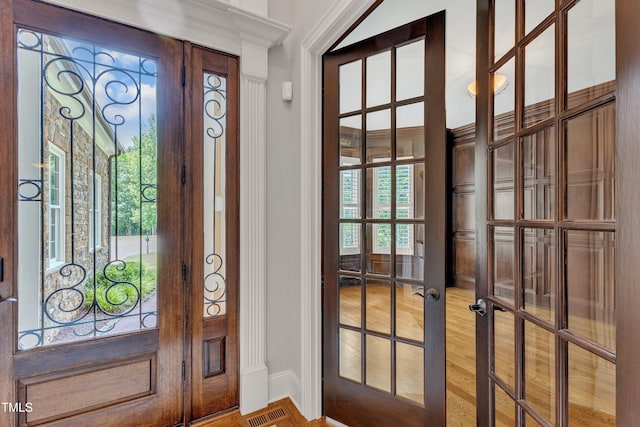 104 Bellagio Dr, Apex, NC 27539 - foyer entrance with french doors, crown molding, baseboards, and light wood-style floors