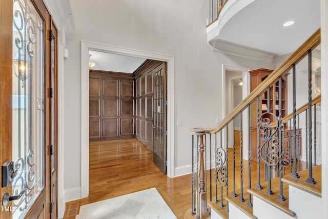 104 Bellagio Dr, Apex, NC 27539 - foyer entrance with light wood finished floors, stairway, crown molding, baseboards, and recessed lighting