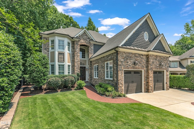 104 Bellagio Dr, Apex, NC 27539 - view of front facade featuring stone siding, concrete driveway, a front yard, a standing seam roof, and a shingled roof