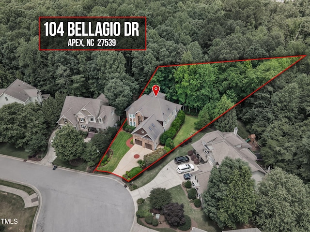 104 Bellagio Dr, Apex, NC 27539 - aerial perspective of suburban area featuring a heavily wooded area and property boundaries highlighted