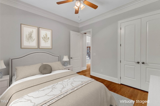 104 Bellagio Dr, Apex, NC 27539 - bedroom with wood finished floors, ornamental molding, baseboards, a ceiling fan, and a closet