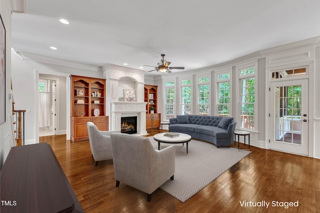 104 Bellagio Dr, Apex, NC 27539 - living area with a ceiling fan, wood finished floors, plenty of natural light, crown molding, and a fireplace