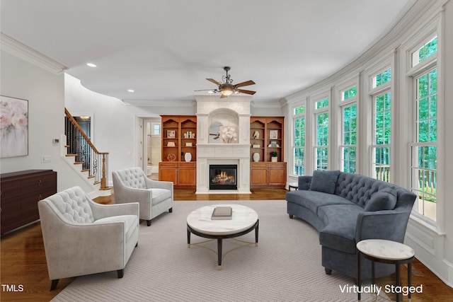 104 Bellagio Dr, Apex, NC 27539 - living area with crown molding, healthy amount of natural light, ceiling fan, wood finished floors, and recessed lighting