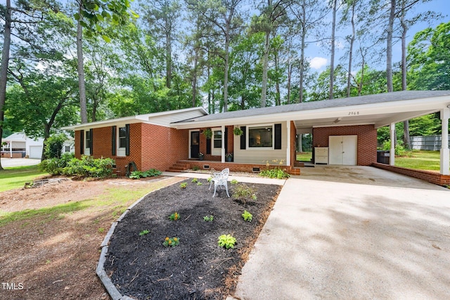 2968 Tram Rd, Fuquay Varina, NC 27526 - view of front of home featuring concrete driveway, brick siding, crawl space, covered porch, and a carport