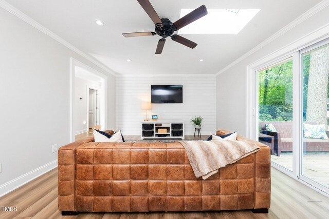 2968 Tram Rd, Fuquay Varina, NC 27526 - living area with light wood-type flooring, ceiling fan, ornamental molding, a skylight, and baseboards