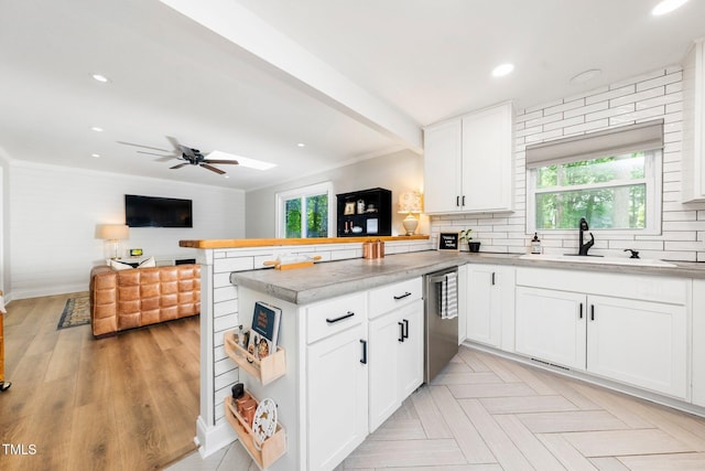 2968 Tram Rd, Fuquay Varina, NC 27526 - kitchen with a peninsula, open floor plan, stainless steel dishwasher, white cabinetry, and backsplash