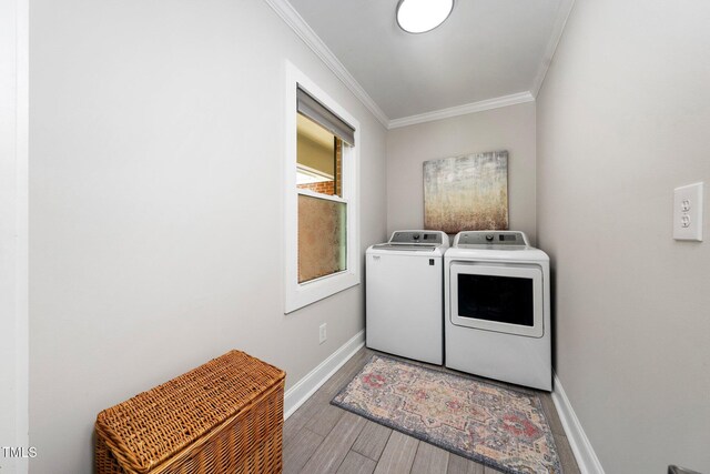 2968 Tram Rd, Fuquay Varina, NC 27526 - laundry area with independent washer and dryer, crown molding, baseboards, and wood finished floors