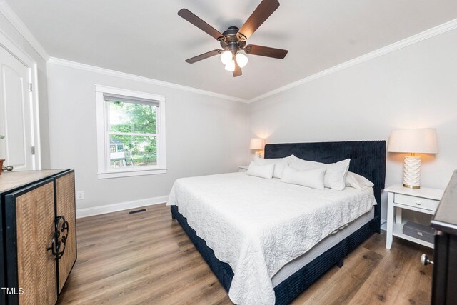 2968 Tram Rd, Fuquay Varina, NC 27526 - bedroom with wood finished floors, baseboards, ornamental molding, and a ceiling fan