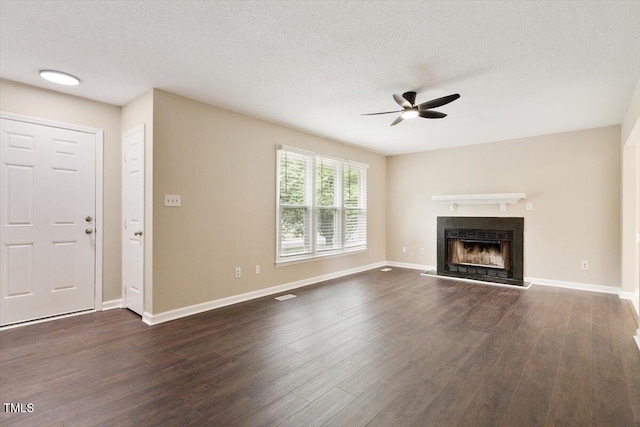 71 E Boxley Dr, Wendell, NC 27591 - unfurnished living room featuring a ceiling fan, dark wood-style flooring, a fireplace, baseboards, and a textured ceiling