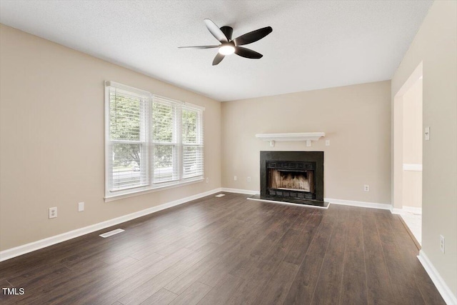 71 E Boxley Dr, Wendell, NC 27591 - unfurnished living room featuring a ceiling fan, a fireplace with raised hearth, dark wood-style floors, and baseboards