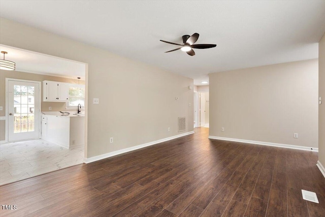 71 E Boxley Dr, Wendell, NC 27591 - unfurnished living room with ceiling fan, dark wood finished floors, and baseboards