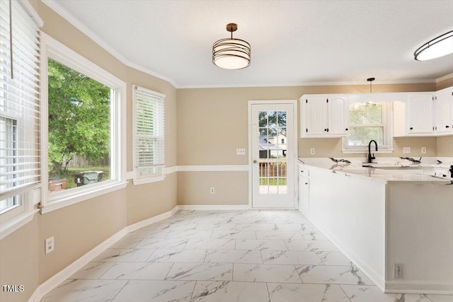 71 E Boxley Dr, Wendell, NC 27591 - kitchen with light marble finish floors, light countertops, white cabinets, baseboards, and crown molding