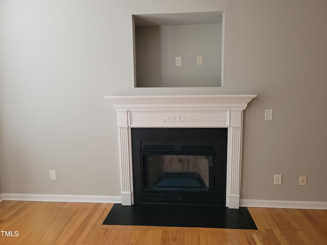 4202 Cherry Blossom Cir, Durham, NC 27713 - detailed view of wood finished floors, a fireplace with flush hearth, and baseboards