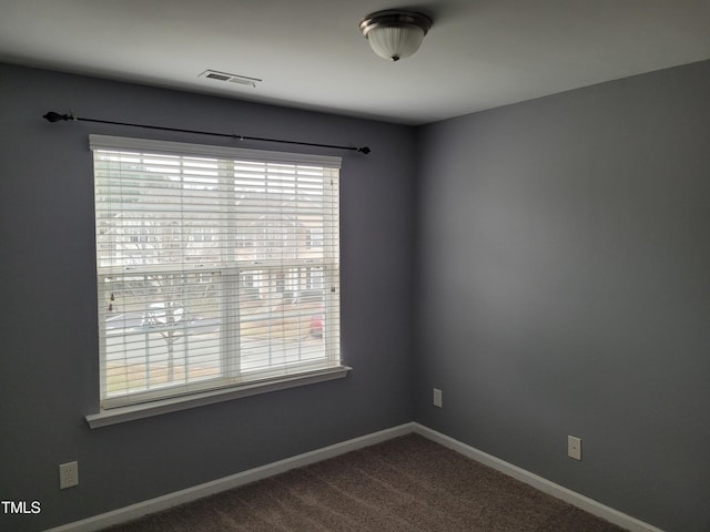 4202 Cherry Blossom Cir, Durham, NC 27713 - spare room featuring baseboards and dark colored carpet