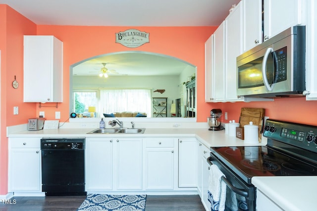 610 Walnut Woods Dr, Morrisville, NC 27560 - kitchen with black appliances, arched walkways, a sink, white cabinets, and light countertops