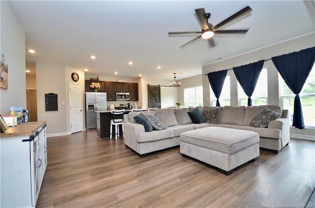 1865 John B Carter Rd, Fayetteville, NC 28312 - living area featuring wood finished floors, recessed lighting, baseboards, ceiling fan, and a chandelier