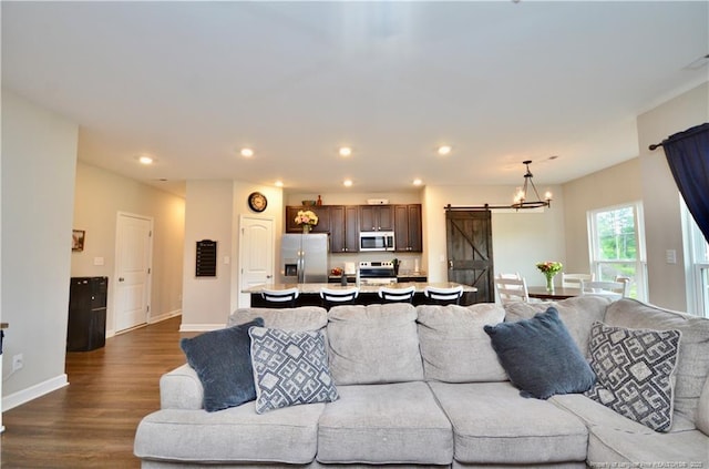 1865 John B Carter Rd, Fayetteville, NC 28312 - living area featuring a barn door, dark wood finished floors, recessed lighting, baseboards, and a chandelier