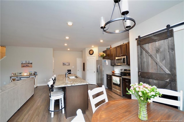 1865 John B Carter Rd, Fayetteville, NC 28312 - kitchen with stainless steel appliances, dark wood-style flooring, a sink, recessed lighting, and an island with sink