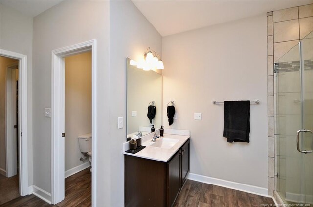 1865 John B Carter Rd, Fayetteville, NC 28312 - bathroom featuring vanity, wood finished floors, a shower stall, and toilet