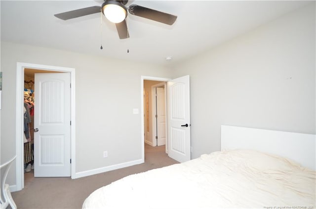 1865 John B Carter Rd, Fayetteville, NC 28312 - bedroom with carpet floors, baseboards, a ceiling fan, and a walk in closet