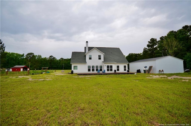 1865 John B Carter Rd, Fayetteville, NC 28312 - back of house featuring a lawn, a chimney, and a wooden deck