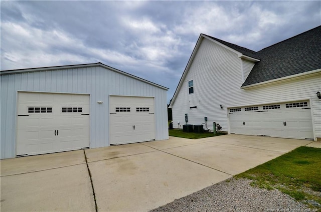 1865 John B Carter Rd, Fayetteville, NC 28312 - view of side of property featuring a garage, a shingled roof, and cooling unit
