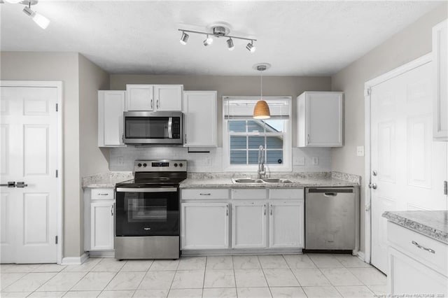 1419 Acacia Dr, Fayetteville, NC 28314 - kitchen with appliances with stainless steel finishes, a sink, white cabinetry, and decorative light fixtures
