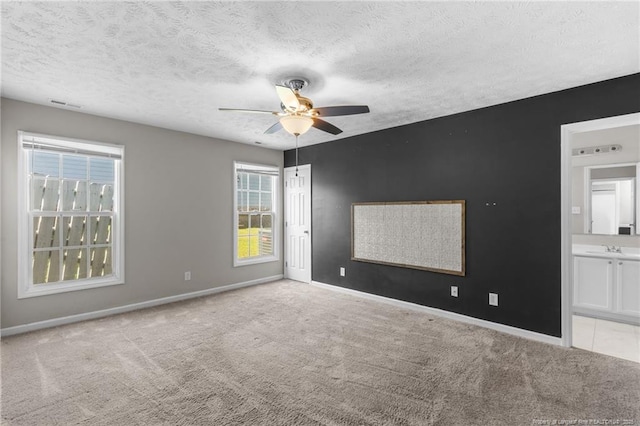 1419 Acacia Dr, Fayetteville, NC 28314 - spare room with light colored carpet, ceiling fan, healthy amount of natural light, baseboards, and a textured ceiling