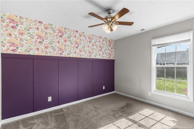 1419 Acacia Dr, Fayetteville, NC 28314 - spare room with healthy amount of natural light, a wainscoted wall, wallpapered walls, a ceiling fan, and a decorative wall