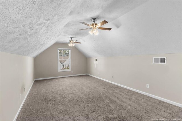 1419 Acacia Dr, Fayetteville, NC 28314 - additional living space featuring baseboards, a ceiling fan, carpet, lofted ceiling, and a textured ceiling