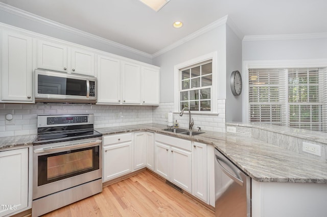 804 Town Side Dr, Apex, NC 27502 - kitchen with appliances with stainless steel finishes, ornamental molding, white cabinets, decorative backsplash, and light wood-style floors