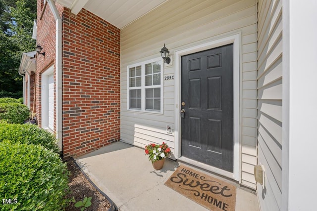 285 Plaza Dr Unit C, Chapel Hill, NC 27517 - view of exterior entry with brick siding and covered porch