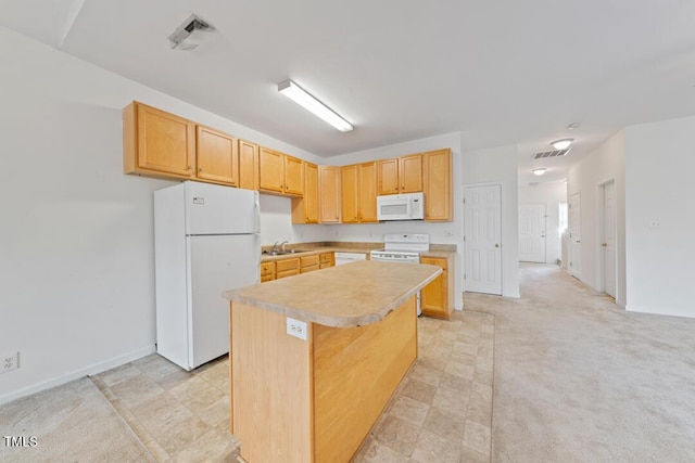285 Plaza Dr Unit C, Chapel Hill, NC 27517 - kitchen with white appliances, a sink, light countertops, a kitchen island, and light brown cabinetry