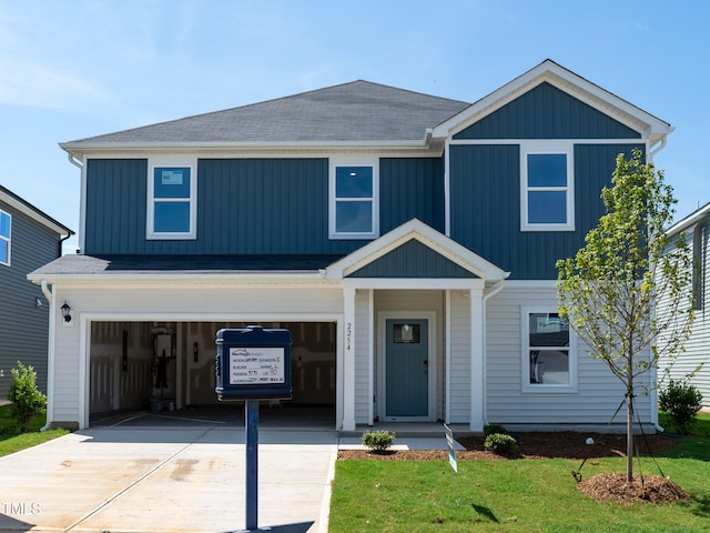 2254 Cherry Creek Rd, Haw River, NC 27258 - view of front facade featuring a garage, driveway, a front yard, and a shingled roof