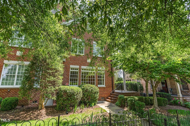 218 W Barbee Chapel Rd, Chapel Hill, NC 27517 - view of front of property featuring a fenced front yard, brick siding, and crawl space
