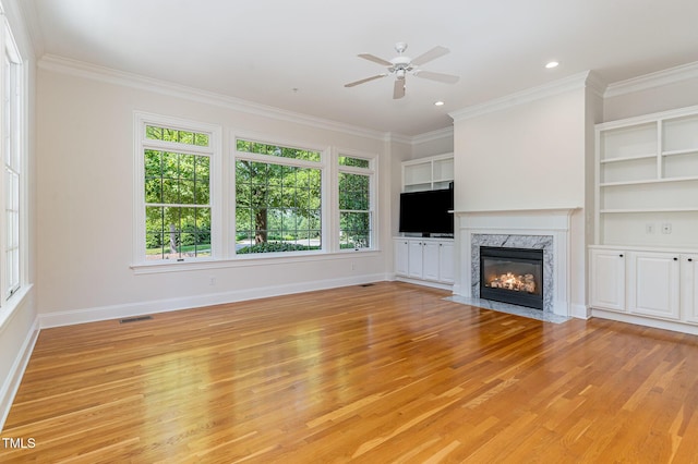 218 W Barbee Chapel Rd, Chapel Hill, NC 27517 - unfurnished living room featuring light wood finished floors, ornamental molding, ceiling fan, baseboards, and a high end fireplace