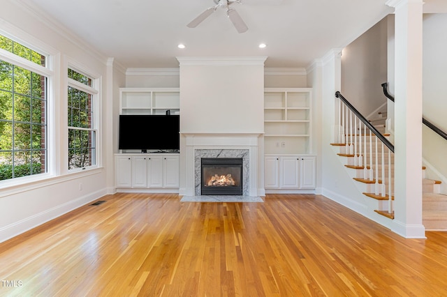 218 W Barbee Chapel Rd, Chapel Hill, NC 27517 - unfurnished living room featuring light wood-style flooring, healthy amount of natural light, stairway, baseboards, and ornamental molding