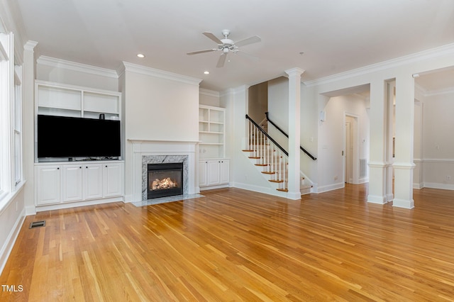 218 W Barbee Chapel Rd, Chapel Hill, NC 27517 - unfurnished living room with light wood-type flooring, a ceiling fan, a fireplace, crown molding, and stairs