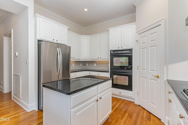 218 W Barbee Chapel Rd, Chapel Hill, NC 27517 - kitchen featuring freestanding refrigerator, light wood-style floors, white cabinets, backsplash, and a center island
