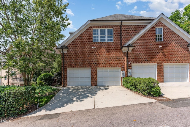 218 W Barbee Chapel Rd, Chapel Hill, NC 27517 - view of front of property with brick siding, an attached garage, and driveway