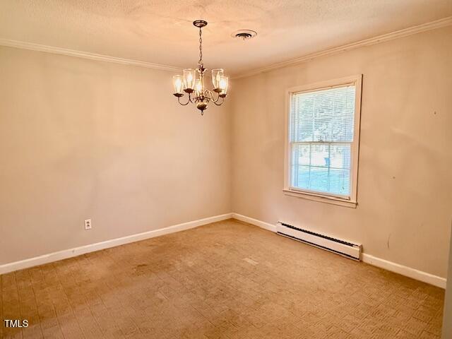 1007 Driftwood Dr, Siler City, NC 27344 - carpeted spare room with baseboard heating, ornamental molding, a chandelier, and a textured ceiling
