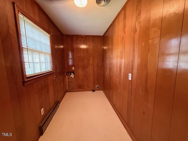 1007 Driftwood Dr, Siler City, NC 27344 - hallway with baseboard heating and wooden walls