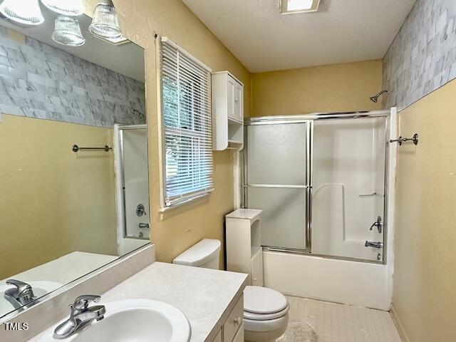 1007 Driftwood Dr, Siler City, NC 27344 - bathroom featuring vanity and combined bath / shower with glass door