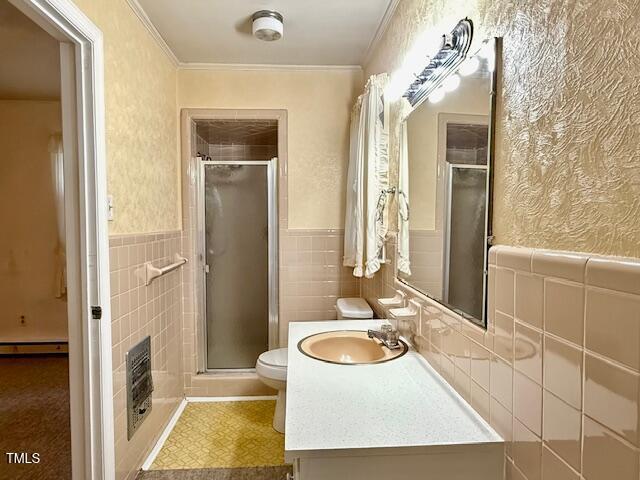 1007 Driftwood Dr, Siler City, NC 27344 - full bath featuring vanity, a shower stall, ornamental molding, tile walls, and a wainscoted wall